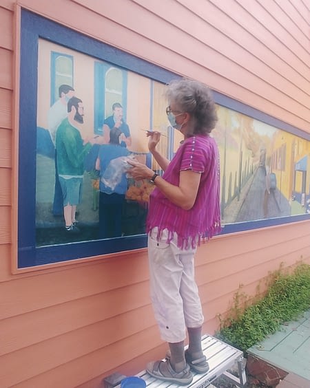 Mary Baker, artist, paints Mexican mural